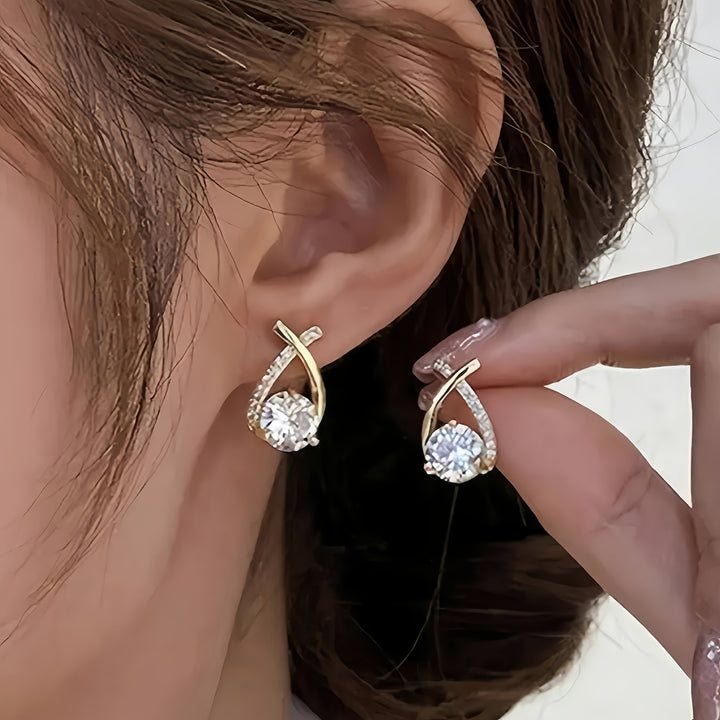 Puces d'oreilles croix dorée avec zircons