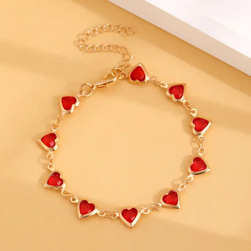 Bracelet doré avec cœur rouge rubis