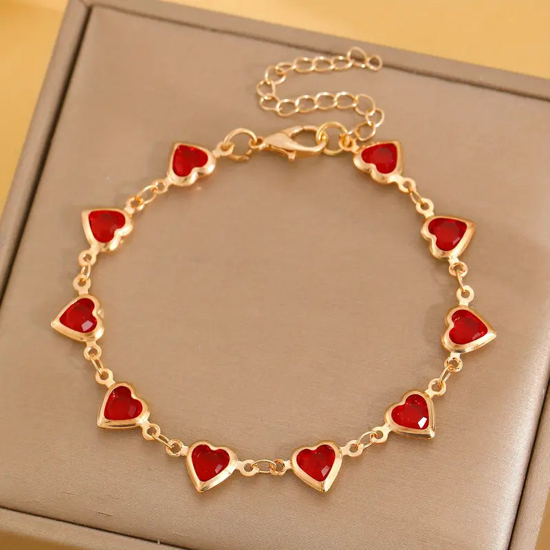 Bracelet doré avec cœur rouge rubis
