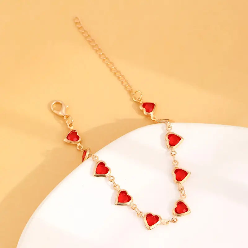 Bracelet doré avec cœur rouge rubis