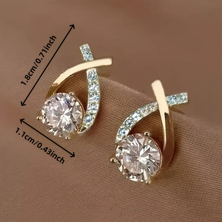 Puces d'oreilles croix dorée avec zircons