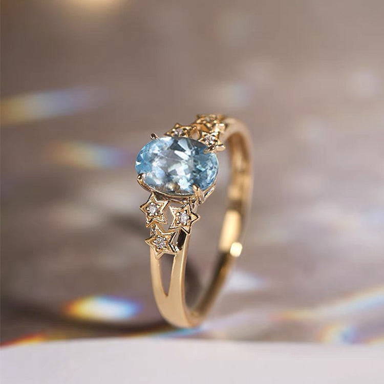 Bague dorée avec cristal bleu