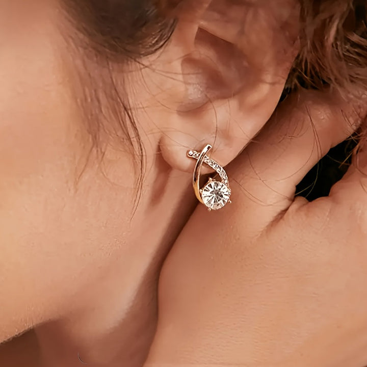 Puces d'oreilles croix dorée avec zircons