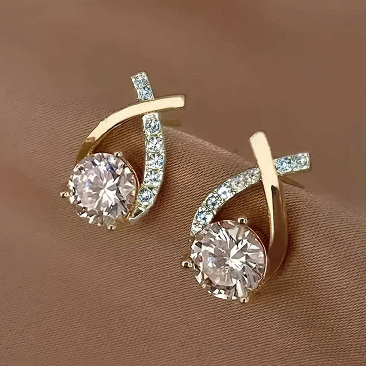 Puces d'oreilles croix dorée avec zircons